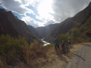 family package peru bike tour, on cliff side with river view